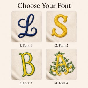 May include: A display of four embroidered font options on a light fabric background. The text 'Choose Your Font' appears at the top. The options include a navy blue script 'L', a yellow 'S', a yellow 'B' with green trim, and a yellow 'A' with green filigree.
