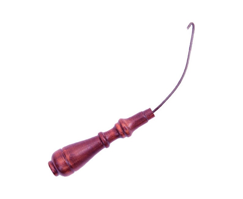 May include: A dark brown wooden handle with a curved metal hook. The handle has a decorative, turned design. The metal hook extends from the handle, curving upwards. The tool is set against a white background.