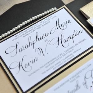 May include: Black and gold wedding invitation with a pearl trim. The invitation reads "Mr. and Mrs. David and Camilla Ortega request the pleasure of your company at the marriage of their daughter Sarahphina to Kevin V. Hampton, Saturday, the fourteenth of May, two thousand sixteen, half-past five in the evening, The Mackey House | Savannah, Georgia, Reception to follow".