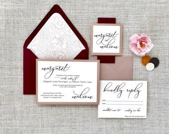 May include: Wedding invitation suite with a burgundy envelope, a blush pink card with the text "margaret & malcom" in black script, and a white card with the text "margaret & malcom" in black script, along with the wedding date, location, and RSVP information.