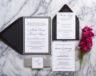 May include: Black and silver wedding invitation suite with a silver glitter envelope, a black inner envelope, and a white RSVP card. The invitation features the couple's names and wedding date, and the RSVP card includes a choice of meal options.