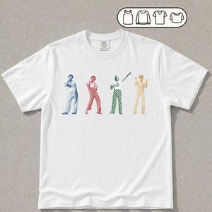 May include: A white short-sleeved t-shirt featuring four graphic figures in blue, red, green, and yellow. Above the shirt, a small icon displays four garment options: a tank top, a long-sleeved shirt, a v-neck, and a short-sleeved t-shirt.