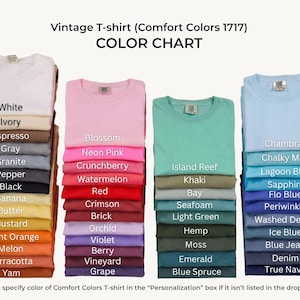 May include: A color chart for Comfort Colors 1717 vintage t-shirts, displaying four vertical stacks of folded shirts in various shades. The text reads: Vintage T-shirt (Comfort Colors 1717) COLOR CHART, with labels for each color listed on the shirts.