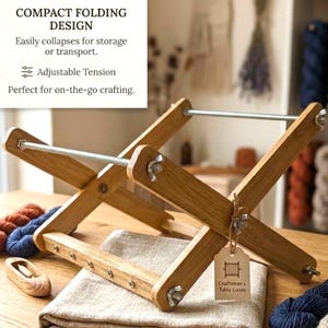 May include: A wooden Craftsman's Table Loom with a compact folding design. The loom is made of light-coloured wood and features adjustable tension. The image also shows yarn and a folded cloth.