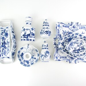 May include: A set of six blue and white porcelain dishes with floral patterns. The set includes a small dish, a larger dish, a small pitcher, a larger pitcher, a small bowl, and a larger bowl.