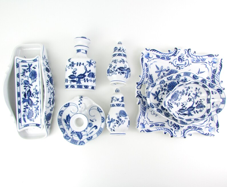 May include: A set of six blue and white porcelain dishes with floral patterns. The set includes a small dish, a larger dish, a small pitcher, a larger pitcher, a small bowl, and a larger bowl.