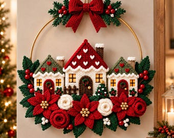 May include: A circular wall hanging featuring a gold metal hoop decorated with crocheted elements. Three small houses with red roofs and white walls are centred, surrounded by red poinsettias, green leaves, red berries, and a red bow.