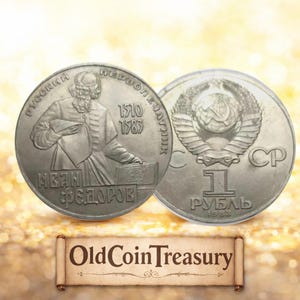 May include: Two silver coins. One coin features a portrait of a man and text in Cyrillic script, with the dates 1510 and 1583. The other coin has a hammer and sickle emblem and the text "1 Рубль" and the date 1988.