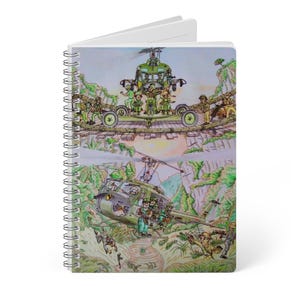 May include: Spiral-bound notebook featuring a colorful illustration of a military helicopter and soldiers in a jungle setting. The artwork depicts a bridge scene with soldiers and a helicopter, with a detailed, artistic style.