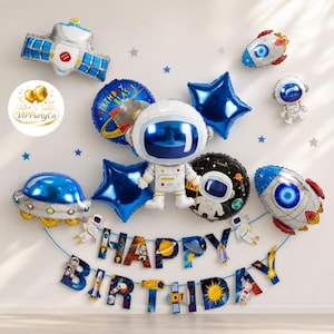 Könnte beinhalten: Eine Sammlung von Weltraum-Geburtstagsdekorationen, darunter Astronauten- und Raketenballons, sternförmige Ballons und ein Banner mit der Aufschrift "HAPPY BIRTHDAY". Das Farbschema umfasst Blau, Silber und Weiß.