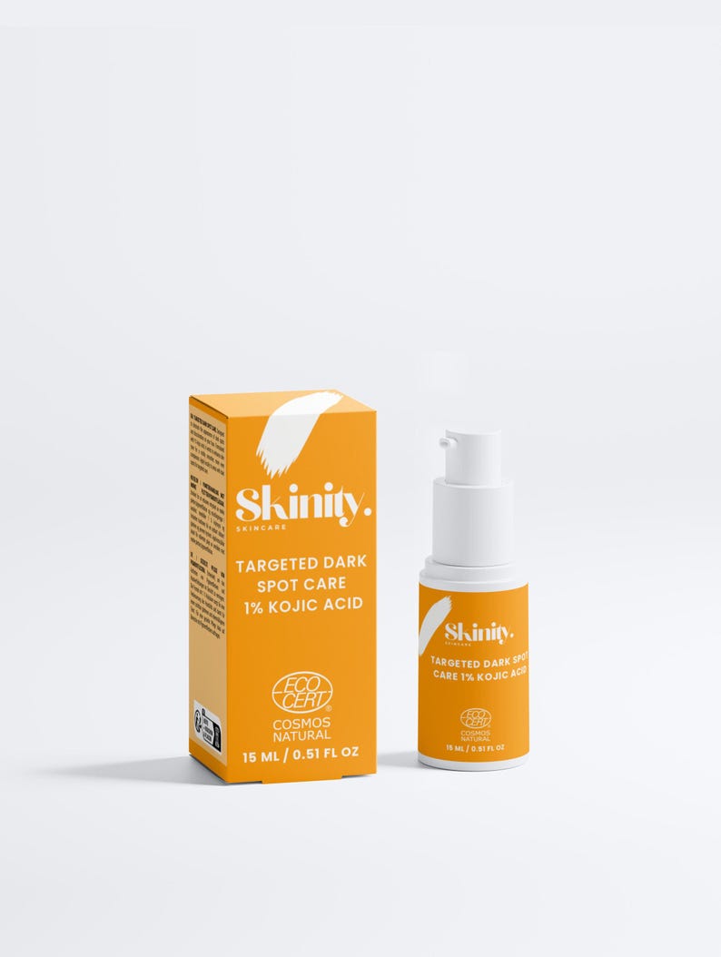 May include: An orange skincare product box and bottle with white accents. The box and bottle both have the brand name "Skinity" and text that reads "Targeted Dark Spot Care 1% Kojic Acid". The bottle contains 15 ml / 0.51 fl oz of product.