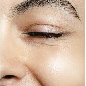 May include: Close-up of a person's closed eye, showcasing detailed skin texture and dark eyelashes. The eyebrow is well-defined with individual hairs visible. The skin has a smooth, healthy appearance, with subtle wrinkles around the eye.
