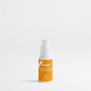 May include: A white and orange skincare product bottle with a pump dispenser. The label reads "Skinity. Targeted Dark Spot Care 1% Kojic Acid". The bottle contains 15 ml / 0.51 fl oz of product.