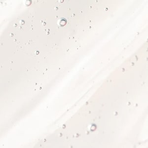 K&ouml;nnte beinhalten: Nahaufnahme einer klaren, viskosen Fl&uuml;ssigkeit mit zahlreichen kleinen, kugelf&ouml;rmigen Blasen. Die Fl&uuml;ssigkeit hat eine leicht cremefarbene Farbe und eine glatte, flie&szlig;ende Textur. Die Blasen variieren in der Gr&ouml;&szlig;e und sind in der Fl&uuml;ssigkeit verstreut.