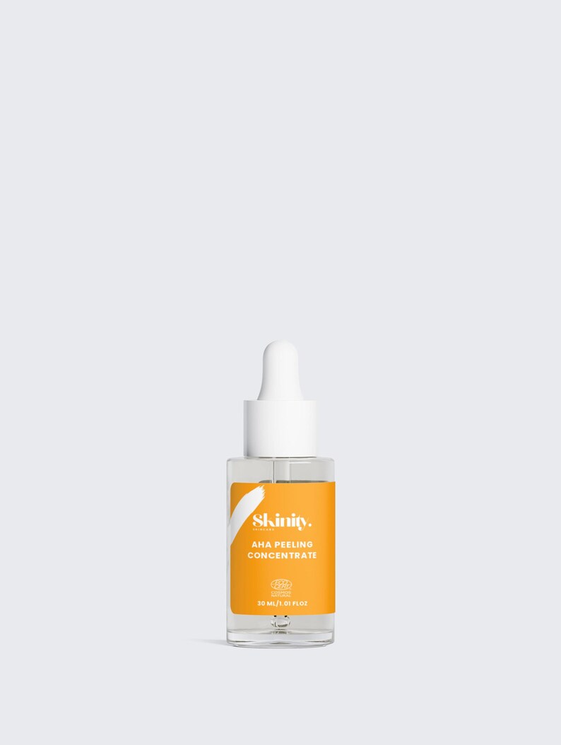 K&ouml;nnte beinhalten: Klarer Glasflakon mit wei&szlig;er Pipette und leuchtend orangefarbenem Etikett. Auf dem Etikett steht "Skinity. AHA PEELING CONCENTRATE" und enth&auml;lt 30 ml. Das Produkt ist f&uuml;r die Hautpflege bestimmt.