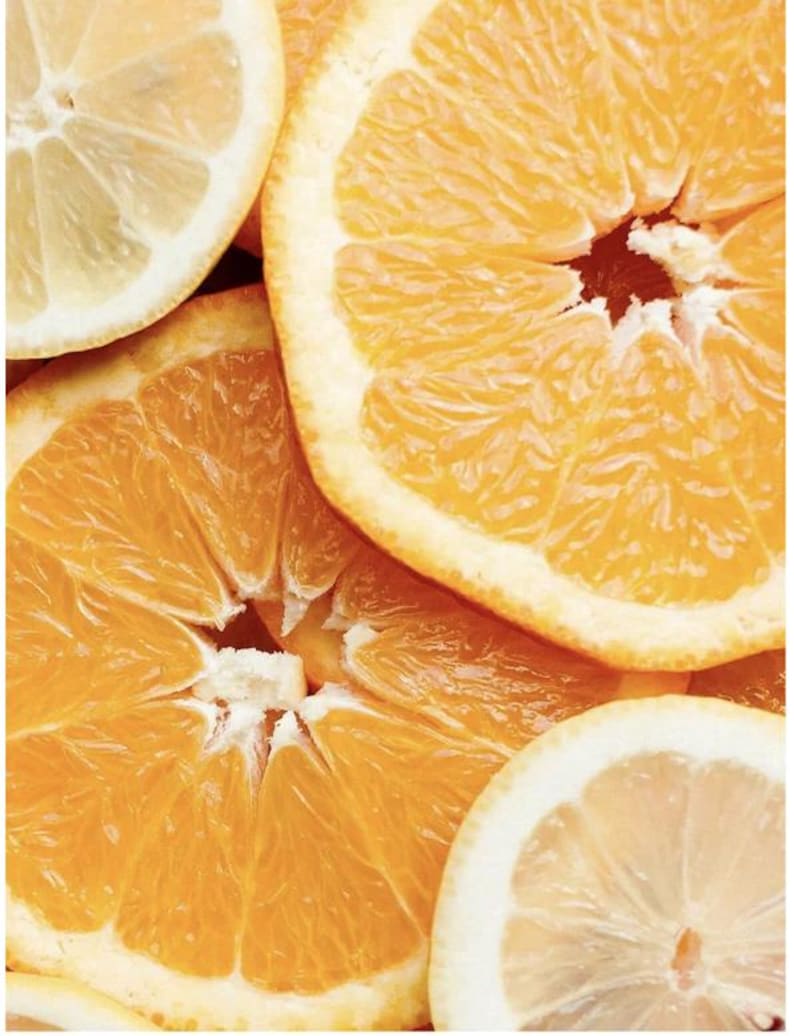 May include: Close-up of sliced oranges and lemons. The image features bright orange and yellow citrus fruit, showcasing the textures of the fruit's flesh and rind. The composition highlights the natural colors and patterns of the fruit.