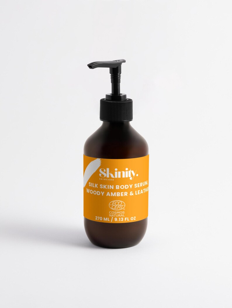 May include: A brown bottle of Skinity Silk Skin Body Serum with a black pump dispenser. The label is orange with white text and a white brushstroke design. The bottle contains 9.13 fl oz (270 ml) of serum.