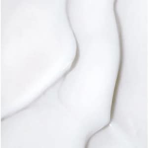 May include: Close-up of a white, flowing, and textured surface. The image shows smooth, curved shapes with highlights and shadows, creating a sense of depth and movement. The overall effect is clean and minimalist.