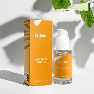 May include: An orange box and a clear glass bottle of Skinity Caffeine Gel Booster. The box and bottle have white text. The bottle contains 30 ml / 1.01 fl oz. Green leaves are in the background.