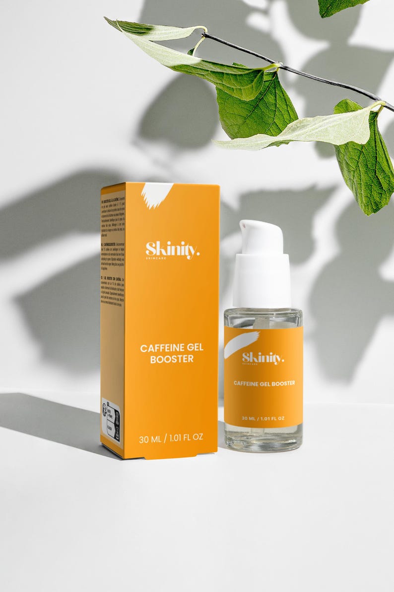 May include: An orange box and a clear glass bottle of Skinity Caffeine Gel Booster. The box and bottle have white text. The bottle contains 30 ml / 1.01 fl oz. Green leaves are in the background.