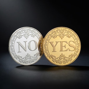 May include: Two decorative coins, one silver and one gold, with the words "NO" and "YES" embossed on them. Both coins have an ornate, swirling border design. The background is black.