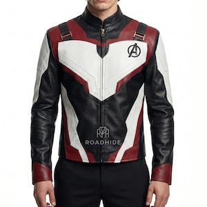 Puede incluir: Chaqueta de cuero negra, blanca y roja con cuello alto y cierre de cremallera. La chaqueta presenta el logotipo de los Vengadores en el pecho y la palabra "ROADHIDE" impresa en la parte delantera. La chaqueta tiene un dise&ntilde;o &uacute;nico con detalles en blanco y rojo.