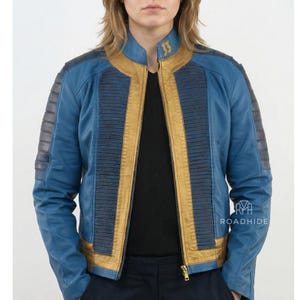 May include: A blue and gold jacket with a stand-up collar and a front zipper. The jacket has gold accents on the front and collar, with the number "33" embroidered on the collar. The sleeves have a textured design.
