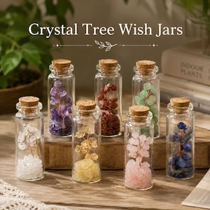 May include: A collection of glass jars with cork stoppers, each filled with colorful crystal trees. The jars contain crystals in various colors, including purple, red, green, yellow, pink, and blue. The text "Crystal Tree Wish Jars" is displayed at the top.