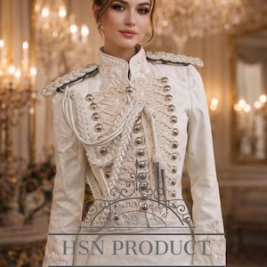 May include: A white military-style jacket with intricate embroidery, silver buttons, and epaulettes. The jacket features a high collar and decorative rope detailing. The text "HSN PRODUCT" and "PREMIUM BRAND" are visible. The jacket is a formal garment.