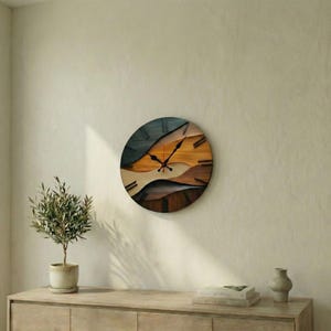 May include: A round wooden wall clock with a layered design in shades of brown, orange, and blue. The clock features black hands and hour markers. The clock is approximately 38 cm in diameter.