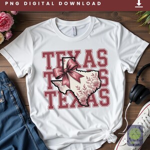 May include: White t-shirt with a maroon graphic that says "TEXAS" three times. The graphic includes a map of Texas with a pink bow and floral design. The words "PNG DIGITAL DOWNLOAD" are at the top.