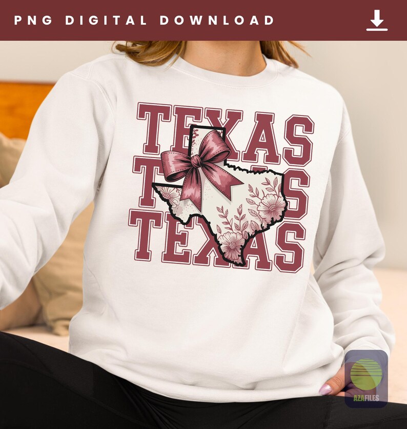 May include: White sweatshirt with the word "TEXAS" in maroon block letters. The state of Texas is depicted in the center, decorated with a pink bow and floral design. The sweatshirt is a casual style.