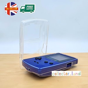 May include: A blue Game Boy Color handheld console with a clear protective case. The console features a screen, buttons, and a speaker. The text "collector_land" is visible on the bottom right.
