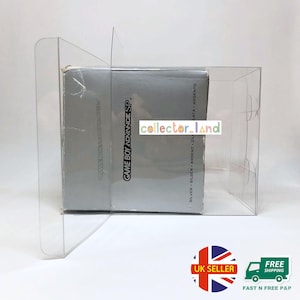 May include: A silver Game Boy Advance SP video game console box is encased in a clear plastic display case. The box has the words "GAME BOY ADVANCE SP" printed on it. The text "collector_land" is also visible.