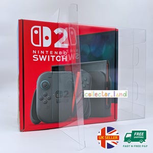 May include: A red Nintendo Switch box with the console and controllers visible, encased in a clear plastic protector. The Nintendo Switch logo and text are in white. The controllers are gray.