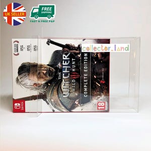 May include: The Witcher 3: Wild Hunt Complete Edition game box for Nintendo Switch. The box art features a detailed illustration of a man with white hair and a sword. The game box is in a clear protective case.