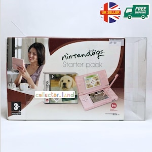 May include: A pink Nintendo DS Lite console and a Nintendogs Starter Pack box. The box features a smiling woman, a puppy, and the text "nintendogs Starter pack". The console is open, displaying a dog-themed game.