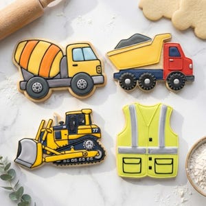May include: A collection of construction-themed cookies, including a cement mixer, dump truck, bulldozer, and safety vest. The cookies are decorated with yellow, orange, red, and blue icing, and are set against a white background.