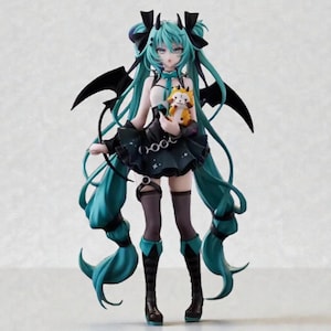 May include: A detailed figurine of a character with long, teal hair and black accents. The figure wears a black dress with a star pattern and holds a small, orange plush. The figure has black wings and is posed against a neutral background.