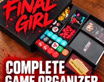 May include: A black board game organizer box labeled FINAL GIRL containing various game components including red heart tokens, blue and red dice with symbols, yellow cubes, and decks of cards labeled ACTION and FOR SHEILA'S EYES ONLY.