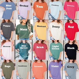 May include: A selection of short-sleeved t-shirts in a range of colours. The colours include blue jean, orchid, yam, chambray, watermelon, pepper, moss, mustard, ivory, red, blossom, blue spruce, brick, light green, black, sage, sandstone, terracotta, violet, and grey.