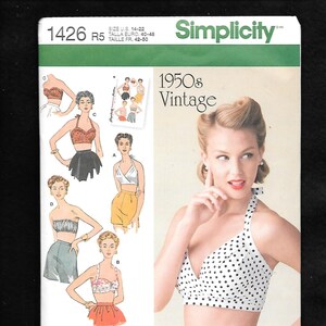 May include: Simplicity pattern 1426 R5 for vintage 1950s style tops. The pattern includes illustrations of various halter tops and a woman wearing a white polka dot halter top. The pattern is designed and printed in the USA.