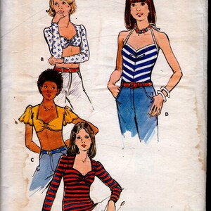 May include: Vintage Butterick sewing pattern, size 10, featuring illustrations of four different tops. The tops include a halter top, a striped top, and a floral print top. The pattern is for super stretch knits.