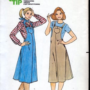 May include: Vintage Butterick sewing pattern 5958 showing two women in jumper dresses. The illustration depicts a blue denim jumper and a tan jumper. The pattern includes size 14 and time-saving tips for topstitching.