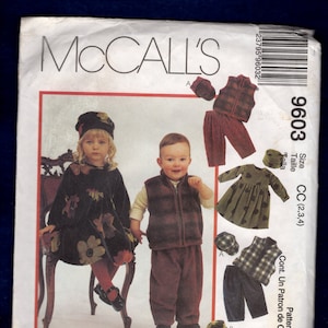 May include: A sewing pattern for children's clothing, McCall's 9603, Cozy Togs. The pattern includes a dress, a vest, and pants. The pattern is for sizes 2, 3, and 4.