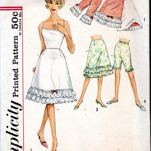May include: Vintage Simplicity sewing pattern featuring a white dress with a lace trim, and other garment options. The pattern includes a skirt, shorts, and capri pants. The waist size is 26 inches, and the hip size is 36 inches.