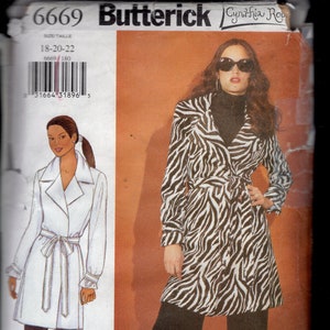 May include: A sewing pattern for a wrap coat with a zebra print design. The pattern is from Butterick and is for sizes 18-20-22. The pattern number is 6669.