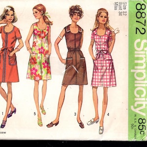 May include: Vintage Simplicity sewing pattern featuring five different dress designs. The dresses have various styles, including floral prints, solid colors, and a plaid pattern. The pattern includes the "Jiffy" logo and text indicating easy cut and sew instructions.
