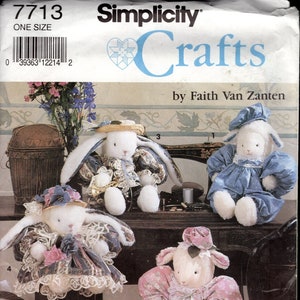May include: A Simplicity Crafts sewing pattern for making four plush toys. The pattern includes instructions for making a bunny wearing a straw hat, a bunny wearing a floral dress, a lamb wearing a blue dress, and a lamb wearing a pink dress. The pattern number is 7713.
