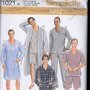 May include: Simplicity sewing pattern 1021A featuring various sleepwear designs. Includes a light blue nightshirt, a gray long-sleeve top and pants, a plaid robe, and a short-sleeve shirt and shorts set. The pattern is for sizes XS-XL.